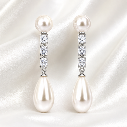 Lunaire pearl drop earrings shown on satin